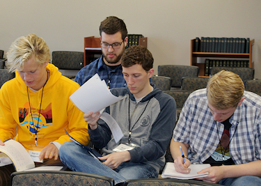 Patrick Waggoner, Nathan Moelker, Micah Shaw, and Caleb Frahm taking notes at the conference